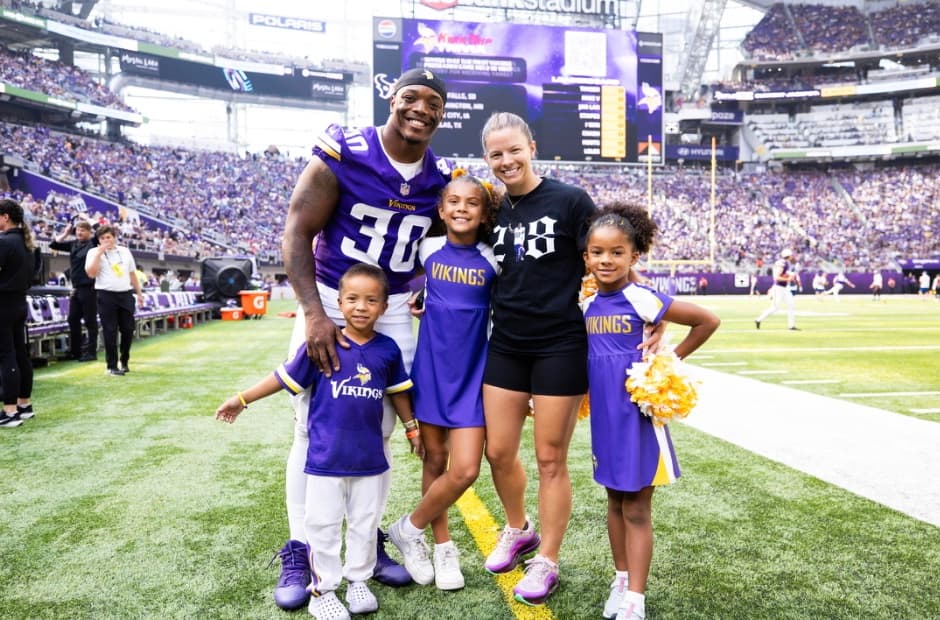 The Ham family on the field, C.J. and Stephanie with Skylar, Stella, and Cortez III